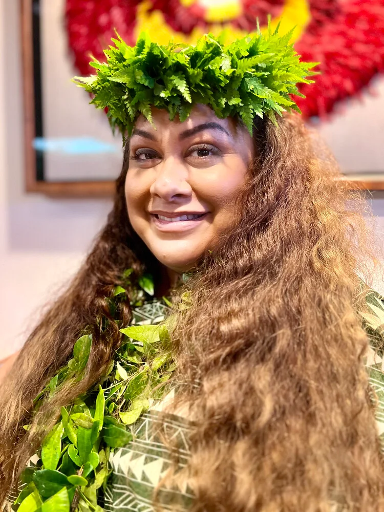 Kumu Hula Shelsea Lilia Ai wearing a green lei poʻo and lei.